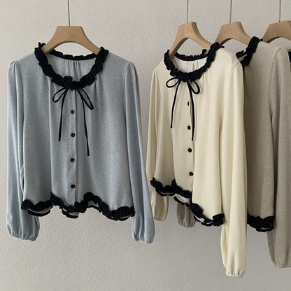 Blusa con fiocco e bordi a contrasto