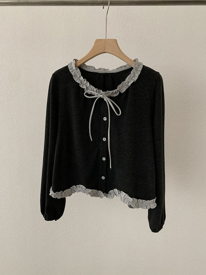Blusa con fiocco e bordi a contrasto