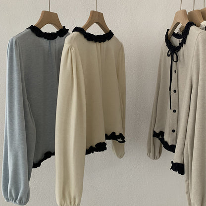 Blusa con fiocco e bordi a contrasto