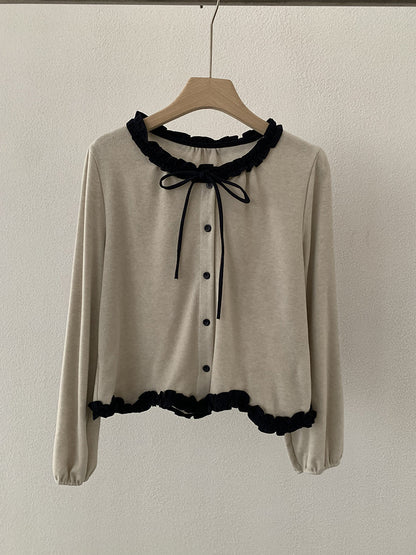 Blusa con fiocco e bordi a contrasto