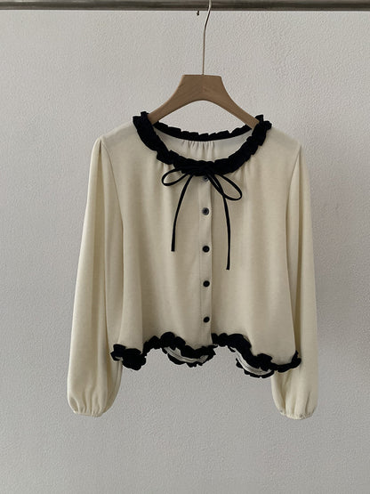 Blusa con fiocco e bordi a contrasto